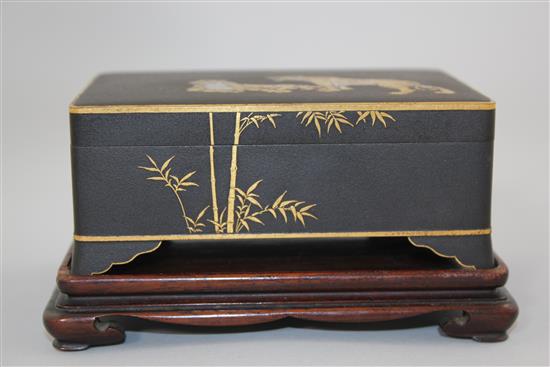 A Japanese gold and silver inlaid iron box and cover, signed Komai, Meiji period, 11cm, rosewood stand